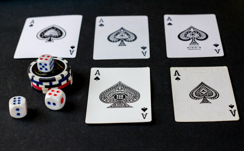 playing cards and dice on a table